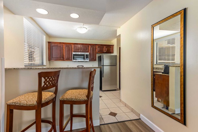 A kitchen with countertop and high chairs