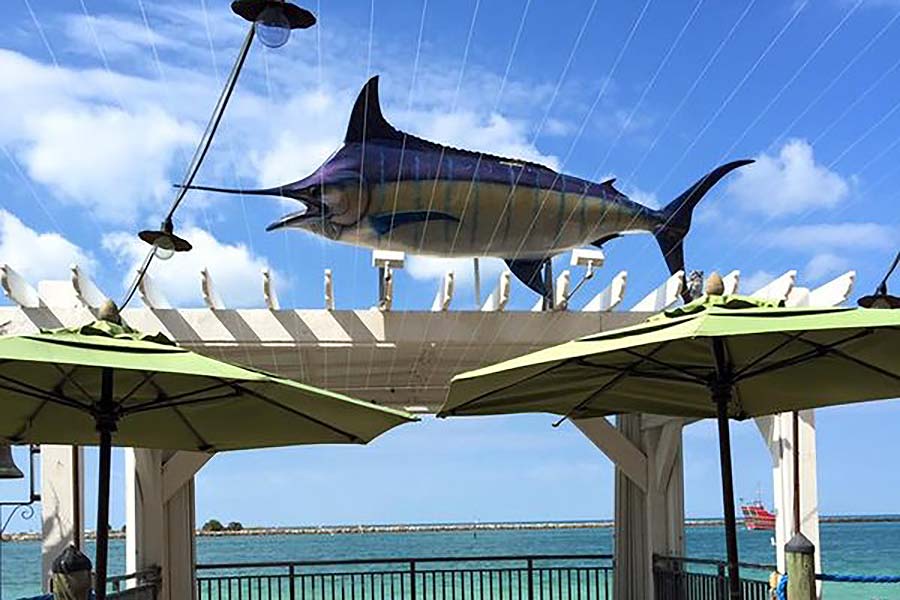 Restaurant with a blue marlin figure on the canopy